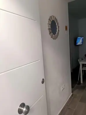 a white door in a room with a mirror at Castelar in Rota