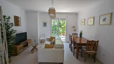 a living room with a white couch and a table at Viva Piso Jerez in Jerez de la Frontera