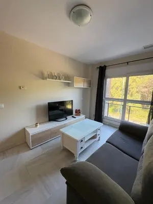 a living room with a couch and a table at Áncora apartamento in El Puerto de Santa María