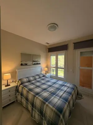 a bedroom with a bed and a window at Áncora apartamento in El Puerto de Santa María