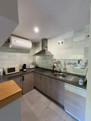 a kitchen with a sink and a stove at Áncora apartamento in El Puerto de Santa María