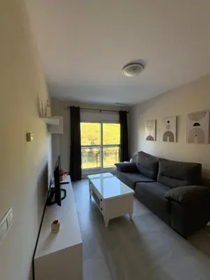 a living room with a couch and a table at Áncora apartamento in El Puerto de Santa María