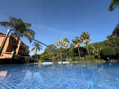 a swimming pool with water fountains in a resort at Áncora apartamento in El Puerto de Santa María