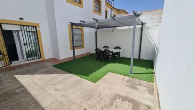 a patio with a table and chairs under a canopy at Vaca House in El Puerto de Santa María