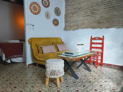 a living room with a couch and a table at Kala Almendrillo Apartment Boutique in Jerez de la Frontera
