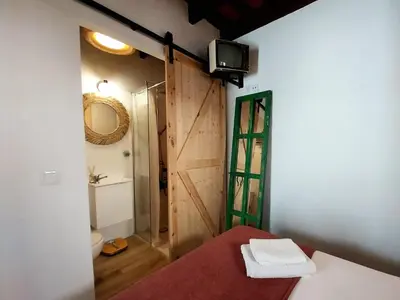 a room with a bathroom with a toilet and a shower at Kala Almendrillo Apartment Boutique in Jerez de la Frontera