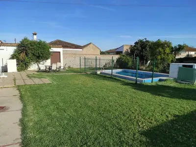 a yard with a swimming pool and a fence at Casa Rural con Piscina Verdugo in El Puerto de Santa María