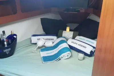 a bed with towels and other items on it at Boat-Apartamento flotante Cádiz.. La Juanita Arroyo in Cádiz