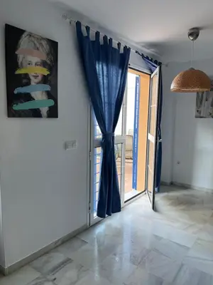 a room with a door with a blue curtain at Fuentebravia House in El Puerto de Santa María