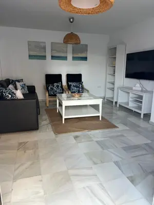 a living room with a couch and a table at Fuentebravia House in El Puerto de Santa María
