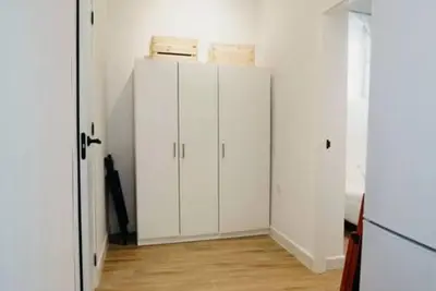 a white closet with white cabinets and a wooden floor at Habana Vieja Cádiz in Cádiz