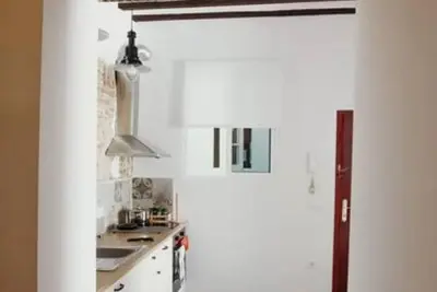 a white kitchen with a sink and a stove at Habana Vieja Cádiz in Cádiz