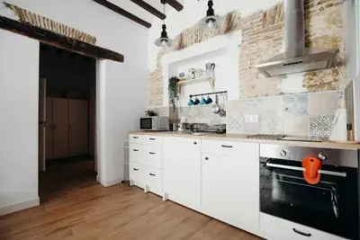 a kitchen with white cabinets and a stove at Habana Vieja Cádiz in Cádiz