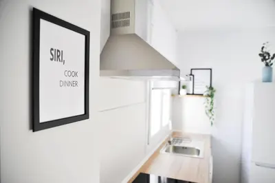 a kitchen with a sink and a picture on the wall at El Apartamento de Nueva in Cádiz