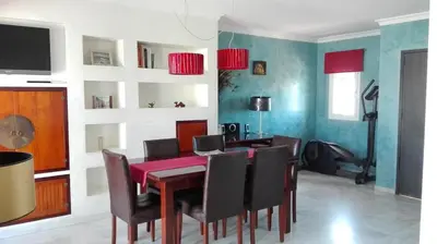 a dining room with a table and chairs at Atico con terraza en centro-playa in Sanlúcar de Barrameda