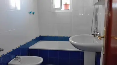 a bathroom with a toilet and a sink and a tub at Atico con terraza en centro-playa in Sanlúcar de Barrameda