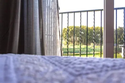 a bedroom with a bed with a view of a window at Casa de campo, llena de encanto junto al mar in Cádiz