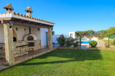 a external view of a villa with a yard at Vivienda Rural El Chirimbolo in Conil de la Frontera