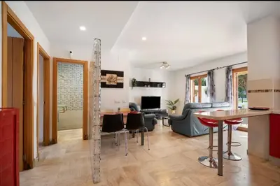 a kitchen and living room with a table and chairs at Carrajolilla Sancti petri in Chiclana de la Frontera