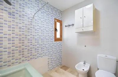 a bathroom with a toilet and a sink and a tub at Carrajolilla Sancti petri in Chiclana de la Frontera