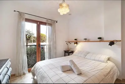 a bedroom with a white bed and a window at Carrajolilla Sancti petri in Chiclana de la Frontera