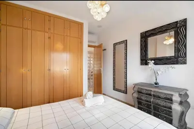 a bedroom with a bed and a mirror at Carrajolilla Sancti petri in Chiclana de la Frontera