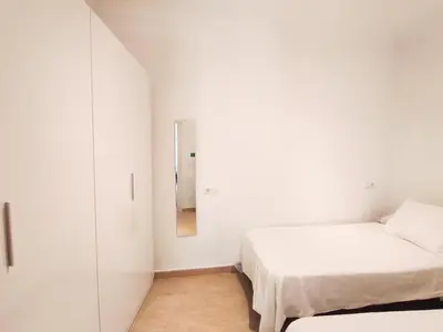 a kitchen with green cabinets and a white refrigerator at Acogedor apartamento in Rota