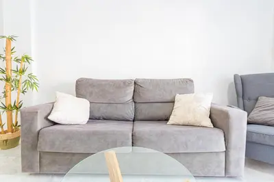 a living room with a couch and a table at Dúplex 8, en primera línea de playa in Sanlúcar de Barrameda