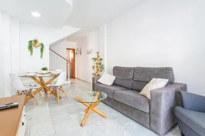 a living room with a couch and a table at Dúplex 8, en primera línea de playa in Sanlúcar de Barrameda