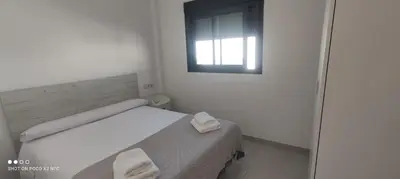 a white room with a bed with a window at APARTAMENTO TURISTICO EN LEBRIJA in Lebrija