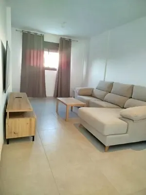 a living room with a couch and a table at APARTAMENTO TURISTICO EN LEBRIJA in Lebrija