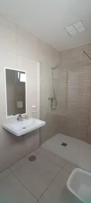 a white bathroom with a sink and a shower at APARTAMENTO TURISTICO EN LEBRIJA in Lebrija