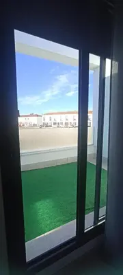 a window with a view of a field of grass at APARTAMENTO TURISTICO EN LEBRIJA in Lebrija