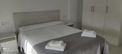 a bedroom with a bed with two towels on it at APARTAMENTO TURISTICO EN LEBRIJA in Lebrija