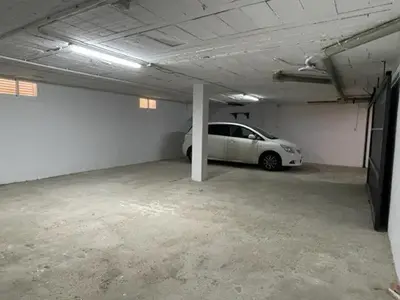 a garage with a white car parked in it at OLEAJE in Sanlúcar de Barrameda
