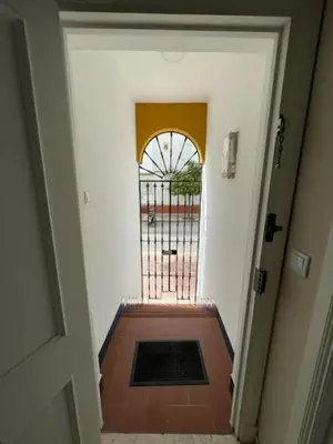 an open door to a hallway with a gate at OLEAJE in Sanlúcar de Barrameda