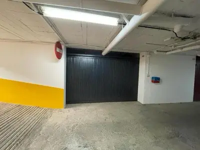 a garage with a black door in a room at OLEAJE in Sanlúcar de Barrameda