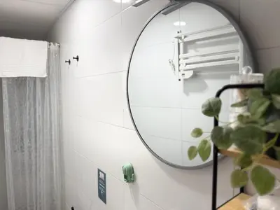 a bathroom with a round mirror on the wall at Estudio Interior Kala - Only Adults - Private Room in Jerez de la Frontera