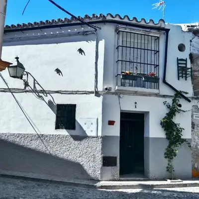 a white building with a window and a door at Estudio Interior Kala - Only Adults - Private Room in Jerez de la Frontera