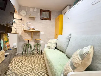 a living room with a couch and two stools at Estudio Interior Kala - Only Adults - Private Room in Jerez de la Frontera