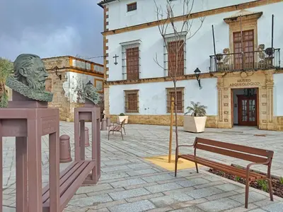 a building with a statue and a bench in a courtyard at Estudio Interior Kala - Only Adults - Private Room in Jerez de la Frontera