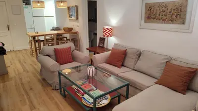 a living room with two couches and a table at Apto. en la playa del parque natural los Turuños in El Puerto de Santa María