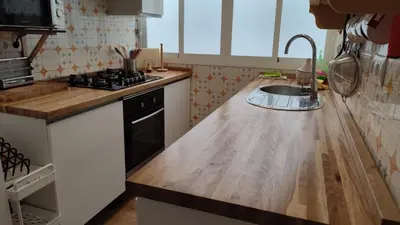 a kitchen with a sink and a wooden counter top at Apto. en la playa del parque natural los Turuños in El Puerto de Santa María