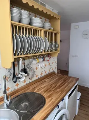 a kitchen with a counter with dishes and a sink at Apto. en la playa del parque natural los Turuños in El Puerto de Santa María