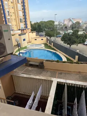 a view of a pool from the balcony of a hotel at Piso de 3 dormitorios con garaje in Jerez de la Frontera