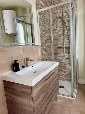 a bathroom with a sink and a shower at Apartamento Fenix - Recién renovado y vistas al mar in Cádiz