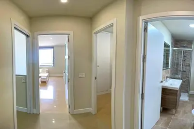 a hallway with two doors and a sink in a room at Apartamento Fenix - Recién renovado y vistas al mar in Cádiz