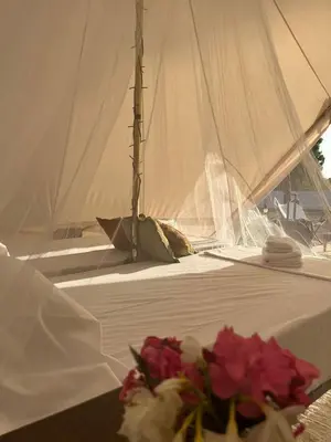 a white table with flowers on it with a sailboat at CÁDIZ -TIPI en Chiclana de la frontera, España in Chiclana de la Frontera