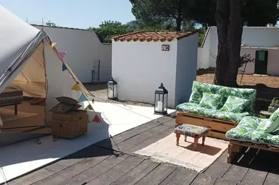 a patio with two chairs and a tent at CÁDIZ -TIPI en Chiclana de la frontera, España in Chiclana de la Frontera