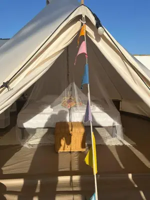 a tent with a string with flags hanging from it at CÁDIZ -TIPI en Chiclana de la frontera, España in Chiclana de la Frontera